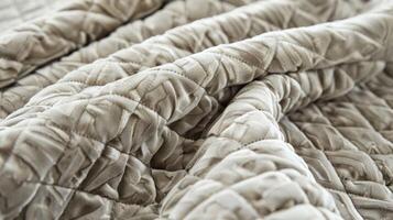 A velvety softness emanates from the intricate diamond patterns of this quilted fabric inviting you to snuggle in and relax photo