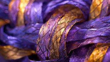 Delicate threads of shimmering violet and gold wrapping and weaving around each other in a captivating display photo