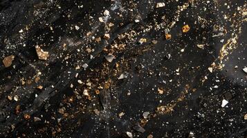 Small glittering flecks of gold and silver embedded in a black granite countertop adding a touch of elegance and luxury photo