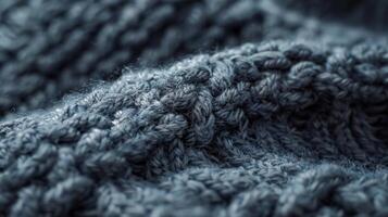 The plush feel of a woolen knit hat with a raised bumpy texture in a muted gray tone giving off a comforting and inviting vibe photo