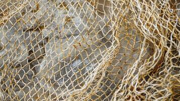 A closeup of a fishing net with small delicate holes that seem to overlap and crisscross each other photo