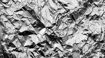 Rugged Holes The rough texture of crinkled aluminum foil is emphasized by the formation of small rugged holes throughout the image photo