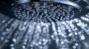 Shiny and lustrous The textured surface of a polished chrome showerhead reflects light like a mirror giving off a radiant and lustrous shine photo