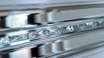 This closeup image focuses on the sparkling edges of the mirrored closet door revealing the fine lines where the glass meets the frame. The delicate beveled edges add a touch of eleganc photo
