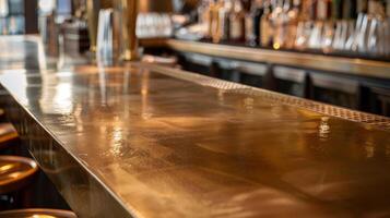 A long rectangular bar with a polished brass finish showing faint scratches and imperfections from years of use and adding character to its sleek appearance photo
