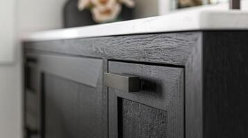 A closer look at a matte black cabinet highlighting the brushed texture that offers a slightly rustic touch to the modern fixture photo