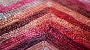 A closeup of the chevron pattern on a rug highlighting the beautiful gradation of colors from deep red to muted pink photo