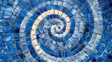 A textured closeup of glossy blue and white mosaic tiles creating a swirling hypnotizing effect as the tiles blend together in a stunning pattern photo