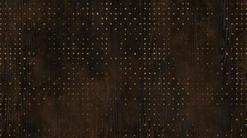 Tiny intricate dots and dashes create a subtle dotted texture on a dark brown surface photo