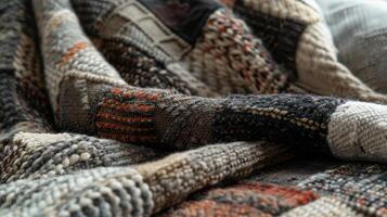 Closeup of a patchwork patterned woolen throw with a variety of earthy tones and different textured weaves photo