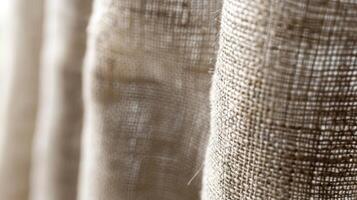 Fine Textured Weave The tightly woven texture of this linen curtain is highlighted in this closeup with tiny fibers creating a fine textured pattern that is pleasing to the touch photo