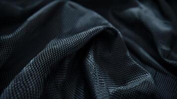 The dark charcoal color of the carbon fiber provides a moody and mysterious look to the tightly knit weave photo