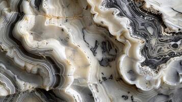 A closeup of a section of a marble column showcasing its smooth swirling patterns of grey and white photo