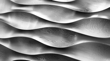 The texture of brushed stainless steel is reminiscent of rippling water with wavy lines running across the surface in a uniform pattern photo