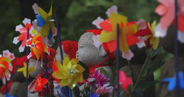 Statue guardian wearing red hat in Tokyo daytime video