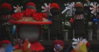 Statue guardian wearing red hat in Tokyo daytime copyspace video