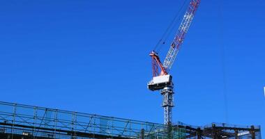 A moving crane at the under construction in Tokyo wide shot video