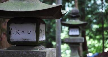 Old Stone lanterns at Japanese old shrine at the countryside close up video