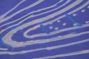 Hand drawn abstract pattern of white stripes of wavy patterns on the wall of a building. White waves and strokes on a blue background. photo