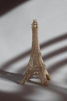 Miniature of Eiffel tower on the table in sunshine. photo