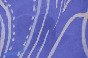 White waves and strokes on a blue background. Hand drawn abstract pattern of white stripes of wavy patterns on the wall of a building. photo