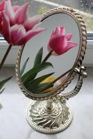 Tulip in reflection of mirror. Mirror and flowers. photo