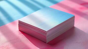 Stack of White Paper on Pink and Blue Background With Sunlight photo