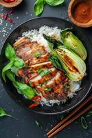 Grilled Chicken With Rice, Basil, and Bok Choy on Black Plate photo