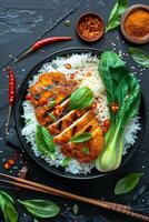Grilled Chicken With Rice, Basil, and Bok Choy on Black Plate photo