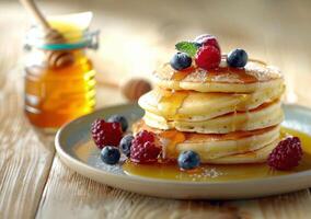 Freshly Made Stack of Pancakes Drizzled With Honey and Topped With Berries on a Wooden Table photo