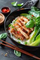 Grilled Chicken With Rice, Basil, and Bok Choy on Black Plate photo