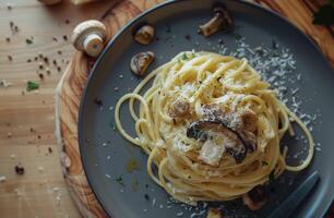Close Up of Spaghetti With Mushrooms and Parmesan Cheese on Gray Plate photo