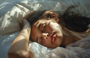 Woman Sleeping Peacefully in Bed With Sunlight photo