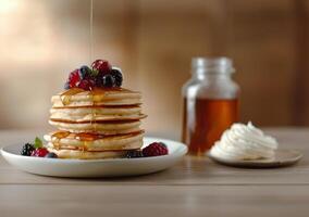 Delicious Stack of Pancakes With Berries and Syrup for Breakfast photo
