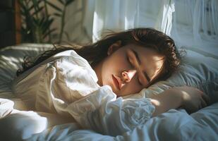 Woman Sleeping Peacefully in Bed With Sunlight photo