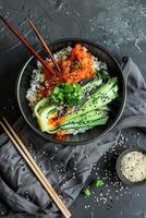 Black Bowl of Rice With Bok Choy, Spicy Sauce, and Sesame Seeds photo