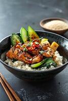 Black Bowl of Rice With Bok Choy, Spicy Sauce, and Sesame Seeds photo