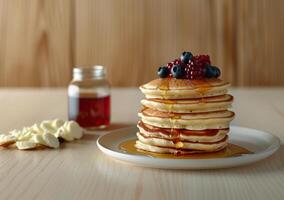 Delicious Stack of Pancakes With Berries and Syrup for Breakfast photo