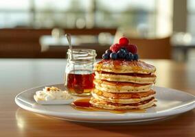 Delicious Stack of Pancakes With Berries and Syrup for Breakfast photo