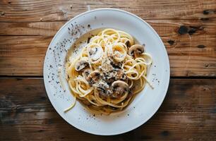 Close Up of Spaghetti With Mushrooms and Parmesan Cheese on Gray Plate photo
