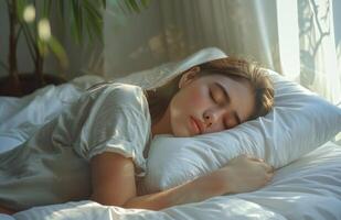 Woman Sleeping Peacefully in Bed With Sunlight photo