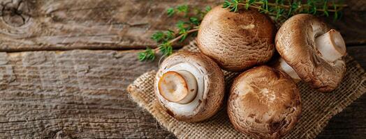 Large Brown Mushrooms in Burlap Sack on Wooden Table photo