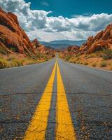 Empty Road Leading Through Red Rock Canyon National Conservation Area photo