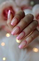 Close Up of a Hand With Pink Ombre Nail Polish photo