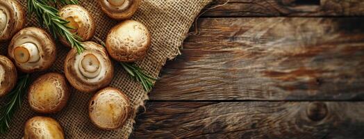 Large Brown Mushrooms in Burlap Sack on Wooden Table photo
