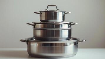 Stack of Three Stainless Steel Pots on Countertop photo