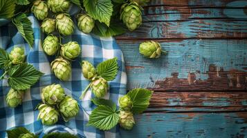Fresh Green Hops on Rustic Wooden Background With Blue Checkered Cloth photo