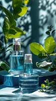 Blue Glass Bottles With Sprayers on Blue Surface Surrounded by Greenery photo