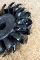 Pelton water turbine on sand with out water photo