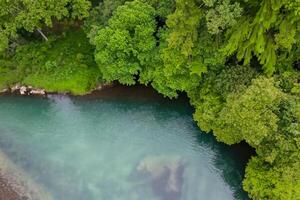 asombroso paisaje un hermosa río fluye mediante encantador aire y lozano árboles, creando un sereno y pintoresco natural refugio para todas a disfrutar foto